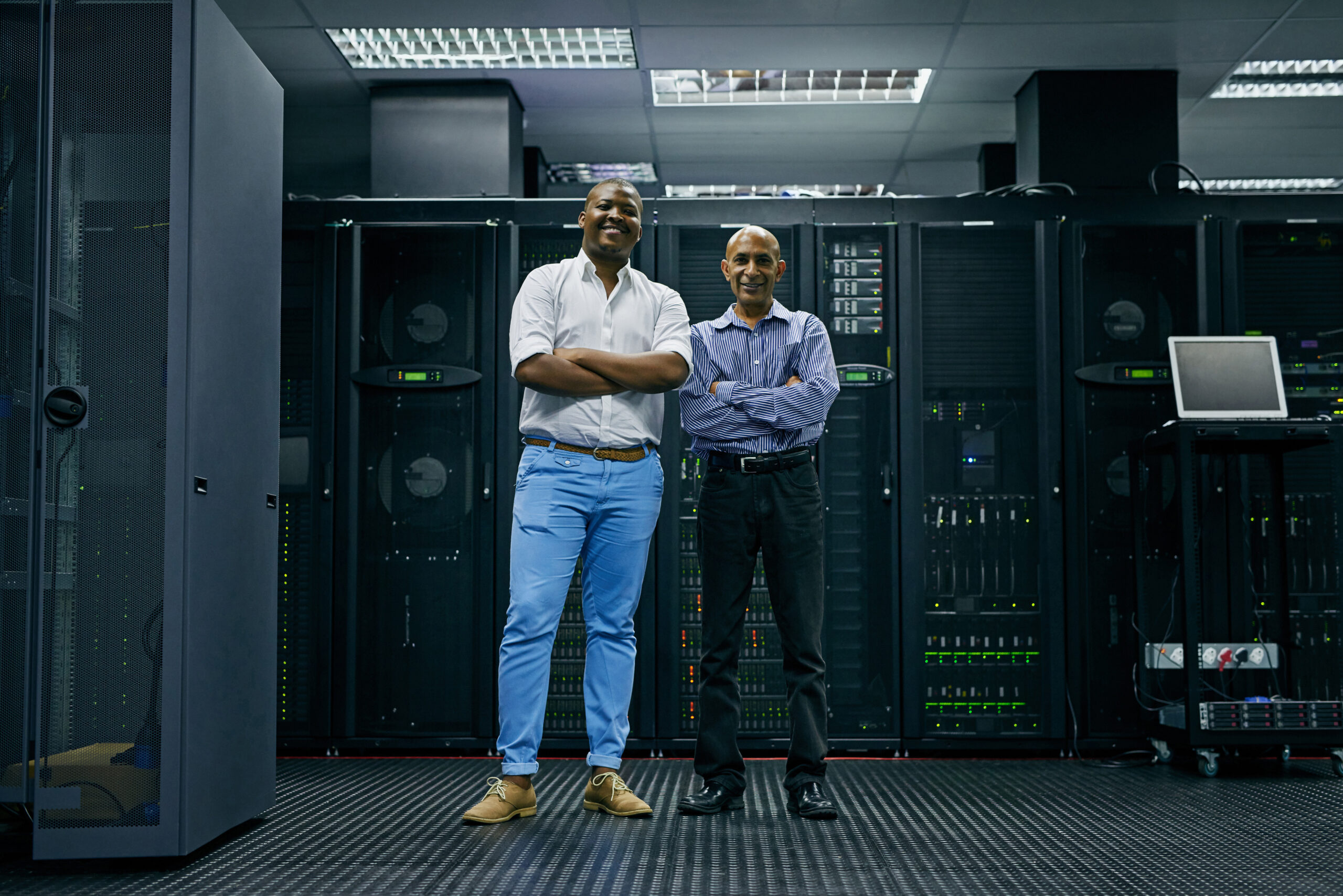 IT support at your service. IT technicians working in a data centre